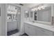 Bathroom with double vanity, updated fixtures, and large mirror at 414 Cerromar S Cir # 249, Venice, FL 34293