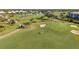 Aerial view of golfers on a beautiful golf course at 414 Cerromar S Cir # 249, Venice, FL 34293