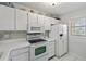 White kitchen with ample cabinetry and modern appliances at 414 Cerromar S Cir # 249, Venice, FL 34293