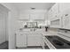 White kitchen with breakfast bar and dishwasher at 414 Cerromar S Cir # 249, Venice, FL 34293