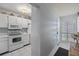 White kitchen with microwave, stove and view of entryway at 414 Cerromar S Cir # 249, Venice, FL 34293
