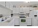 White kitchen with updated appliances and cabinetry at 414 Cerromar S Cir # 249, Venice, FL 34293