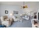 Open living area showcasing comfortable sofas and a view into the kitchen and dining area at 414 Cerromar S Cir # 249, Venice, FL 34293