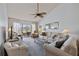 Bright living room with vaulted ceiling, comfy seating, and access to a balcony overlooking golf course at 414 Cerromar S Cir # 249, Venice, FL 34293