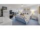 Main bedroom with king-size bed, dresser, and home office area at 414 Cerromar S Cir # 249, Venice, FL 34293