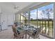 Sunroom with glass doors, view of the golf course, and wicker furniture at 414 Cerromar S Cir # 249, Venice, FL 34293