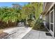 Private backyard patio with lush landscaping and grill at 4498 Diamond E Cir, Sarasota, FL 34233