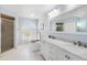 Bathroom with a soaking tub, double vanity, and marble countertop at 4498 Diamond E Cir, Sarasota, FL 34233