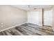 Spacious bedroom featuring wood-look floors and double closets at 4498 Diamond E Cir, Sarasota, FL 34233
