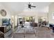 Bright living room featuring a sectional sofa and large windows at 4498 Diamond E Cir, Sarasota, FL 34233
