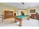 Pool table, Asian-inspired cabinets, and ample space in this game room at 4673 Deer Creek Blvd, Sarasota, FL 34238