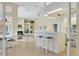 Modern kitchen with white cabinets, breakfast bar, and view to living room at 4673 Deer Creek Blvd, Sarasota, FL 34238