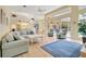 Living room with blue rug and view into kitchen area at 4673 Deer Creek Blvd, Sarasota, FL 34238