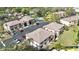 Aerial view showing condo buildings, parking, and surrounding landscape at 5026 Water Oak Dr # 105, Bradenton, FL 34207