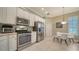 Modern kitchen featuring stainless steel appliances and white cabinetry at 5272 Highbury Cir, Sarasota, FL 34238