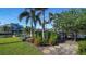 Landscaped backyard with lush greenery and stone pathway leading to canal at 5981 Emerald Harbor Dr, Longboat Key, FL 34228