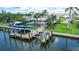 Aerial view of waterfront home with private boat dock and lift at 5981 Emerald Harbor Dr, Longboat Key, FL 34228