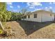 Single story home with screened porch and partial view of yard at 6015 Florida St St, Punta Gorda, FL 33950