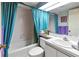 Bathroom with bathtub, toilet and teal curtains at 636 Estuary Dr # 636, Bradenton, FL 34209