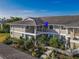 Tan two-story condo building with gray tile roof, landscaping, and walkway at 636 Estuary Dr # 636, Bradenton, FL 34209