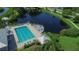 Community pool with lounge chairs and a view of a lake at 636 Estuary Dr # 636, Bradenton, FL 34209