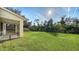 Spacious backyard with grassy lawn and screened porch at 6963 74Th Street E Cir, Bradenton, FL 34203