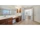 Double vanity bathroom with access to bedroom and hallway at 6963 74Th Street E Cir, Bradenton, FL 34203