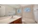 Clean bathroom with tub, vanity, and mirrored medicine cabinet at 6963 74Th Street E Cir, Bradenton, FL 34203