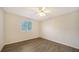 Well-lit bedroom featuring wood-look floors and a ceiling fan at 6963 74Th Street E Cir, Bradenton, FL 34203