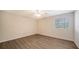 Simple bedroom with wood-look floors and a window with blinds at 6963 74Th Street E Cir, Bradenton, FL 34203