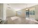 Dining room with tile floors, sliding glass doors to the backyard, and a view of the staircase at 6963 74Th Street E Cir, Bradenton, FL 34203