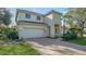 Two-story house with white exterior, brick driveway, and landscaping at 6963 74Th Street E Cir, Bradenton, FL 34203