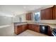 Kitchen with wooden cabinets and black appliances at 6963 74Th Street E Cir, Bradenton, FL 34203