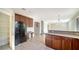 Kitchen with wooden cabinets, pantry, and appliances at 6963 74Th Street E Cir, Bradenton, FL 34203