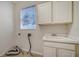 Laundry room with sink, cabinets, and window at 6963 74Th Street E Cir, Bradenton, FL 34203