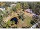 Aerial view showing home, pond, and surrounding trees at 7321 Proctor Rd, Sarasota, FL 34241