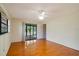 Bright bedroom with wood floors and sliding glass doors leading to the outdoors at 7321 Proctor Rd, Sarasota, FL 34241