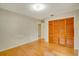 Bedroom with wood floors and built-in closet with bi-fold doors at 7321 Proctor Rd, Sarasota, FL 34241