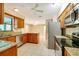 Spacious kitchen with wood cabinets, granite counters, and stainless steel appliances at 7321 Proctor Rd, Sarasota, FL 34241
