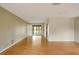 Bright living room with wood floors and sliding glass doors leading to backyard at 7321 Proctor Rd, Sarasota, FL 34241