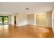 Large living room with wood-look floors and access to the kitchen and patio at 7321 Proctor Rd, Sarasota, FL 34241