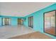 Spacious teal-painted patio with sliding glass doors at 7321 Proctor Rd, Sarasota, FL 34241