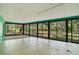 Large screened porch with view of backyard and trees at 7321 Proctor Rd, Sarasota, FL 34241