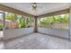 Bright screened porch features a ceiling fan and views of the backyard at 7530 42Nd E Ct, Sarasota, FL 34243