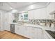 Modern kitchen with white cabinets, quartz countertops, and gold accents at 1501 Ridgewood Ln, Sarasota, FL 34231