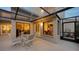 Elegant outdoor patio with seating and views into the home's interior, enhanced by natural light and inviting décor at 2203 Harbourside Dr, Longboat Key, FL 34228
