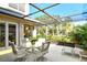 Screened patio features an outdoor dining area and views of the surrounding landscape at 2203 Harbourside Dr, Longboat Key, FL 34228