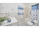 Clean bathroom with blue and white tile and a bathtub at 2509 14Th W Ave, Bradenton, FL 34205