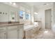 Bright bathroom featuring double sinks, soaking tub and travertine tile floor at 4742 Balboa Park Loop, Bradenton, FL 34211
