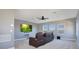 Comfortable entertainment room featuring three large windows, a ceiling fan, and wall mounted television at 4742 Balboa Park Loop, Bradenton, FL 34211